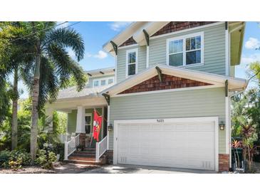 Charming two-story home featuring a well-manicured lawn, two-car garage, and inviting front porch at 4603 S Bartlett St, Tampa, FL 33611