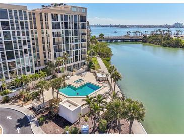 Enjoy waterfront views from this condo with a lovely in-ground pool and jacuzzi surrounded by mature palm trees at 7400 Sun Island Drive S # 712, South Pasadena, FL 33707
