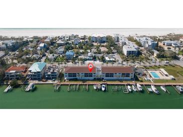 Beautiful waterfront condos with docks along pristine coastline and views of the clear blue water and sandy beach at 3111 Pass A Grille Way # 213, St Pete Beach, FL 33706