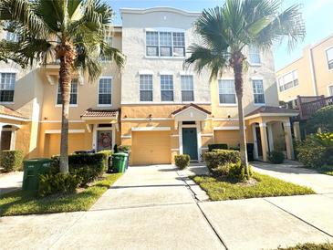 Charming two-story townhome with well-manicured landscaping and two palm trees for added curb appeal at 3128 Bayshore Oaks Dr, Tampa, FL 33611