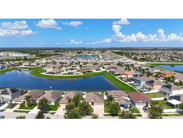Wide aerial view of a beautiful community centered around a large pond on a bright, sunny day at 924 Peregrine Hill Pl, Ruskin, FL 33570