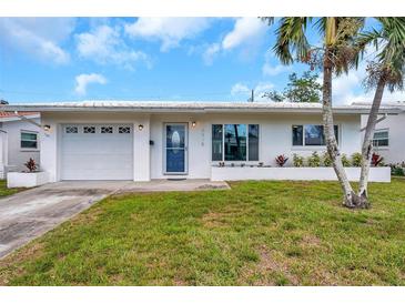 Charming single-story home with a manicured lawn and beautiful blue door at 9915 39Th N St # 3, Pinellas Park, FL 33782