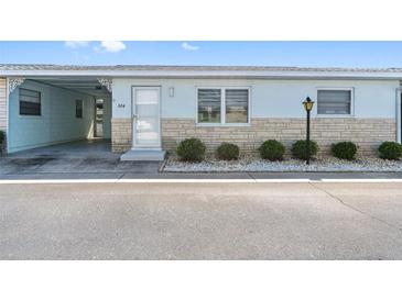 Charming condo featuring a light blue exterior, white trim, and well-maintained landscaping at 12400 Park Blvd # 524, Seminole, FL 33772