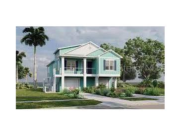 Charming coastal home featuring a two-story design, inviting porch and lush landscaping at 344A Bay St, Palm Harbor, FL 34683