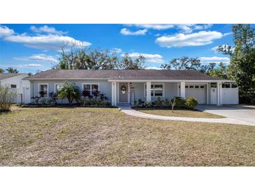 Charming single-story home features a well-manicured lawn and attached garage at 1316 W Hiawatha St, Tampa, FL 33604