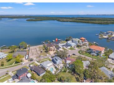 Stunning aerial view of waterfront homes with docks, surrounded by beautiful blue water and lush greenery at 1843 Bayou Grande Ne Blvd, St Petersburg, FL 33703