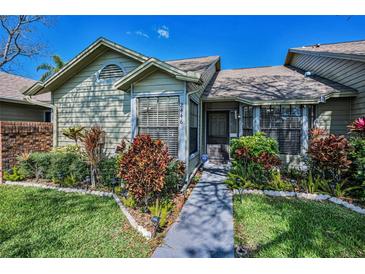 Well maintained home with manicured front yard, and mature landscaping at 2446 Bentley Dr, Palm Harbor, FL 34684