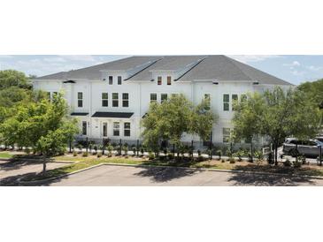 Charming townhome with a manicured lawn and black aluminum fence surrounding the property at 4717 W Mccoy St # 18, Tampa, FL 33616