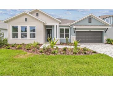 Beautiful home with a well-manicured lawn and appealing landscaping at 31430 Hayman Loop, Wesley Chapel, FL 33545