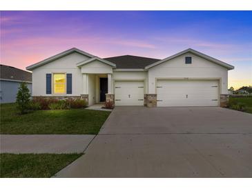 Charming single-Gathering home featuring a two-car garage and well-manicured lawn at 3528 Golden Wheat Ln, Plant City, FL 33565