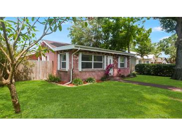 Charming single-story brick home featuring a well-manicured lawn and mature landscaping at 4424 19Th N St, St Petersburg, FL 33714