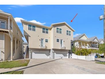A charming, multi-level house with a two-car garage, balcony, and well-maintained landscaping, perfect for comfortable living at 4859 W Prescott St, Tampa, FL 33616
