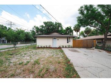 Charming single-story home featuring a neutral exterior, updated landscaping, and a private driveway at 8319 N 14Th St, Tampa, FL 33604