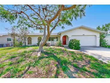 Charming single-story home features a well-kept lawn and a mature tree in a desirable location at 1831 Kay Dr, Largo, FL 33770