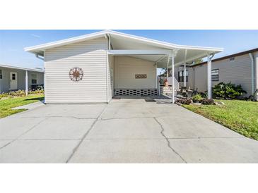 Charming home with a covered carport and well-maintained lawn, perfect for enjoying outdoor living at 3110 Moss Hill St, Wesley Chapel, FL 33543