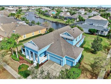 Stunning waterfront property with a private dock, lush landscaping, and a spacious layout for luxurious living at 613 Manns Harbor Dr, Apollo Beach, FL 33572