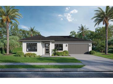 Charming single-story home featuring a two-car garage, minimalist landscaping, and a stylish, modern exterior at 1014 E 21St Ave, Tampa, FL 33605