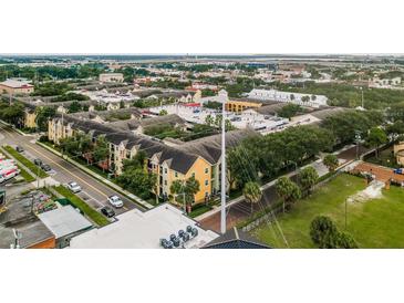 Aerial view of a colorful apartment complex featuring well-maintained landscaping and ample parking at 1810 E Palm Ave # 7104, Tampa, FL 33605