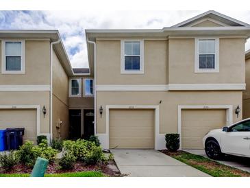 Inviting townhome with a beige exterior, two-car garage, and manicured landscaping in a desirable neighborhood at 2153 Broadway View Ave, Brandon, FL 33510