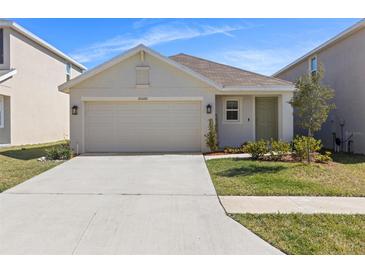 Charming single-story home featuring a two-car garage, well-manicured lawn and beautifully landscaped yard at 35320 Spruce Knob Ct, Dade City, FL 33525