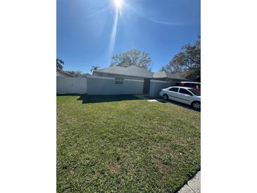 Cozy single-story home with a well-maintained lawn and a bright, sunny day at 5920 Bitterwood Ct, Tampa, FL 33625