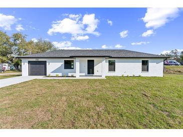 Charming one-story home featuring a well-manicured lawn, single car garage, and modern design elements at 114 25Th E St, Palmetto, FL 34221