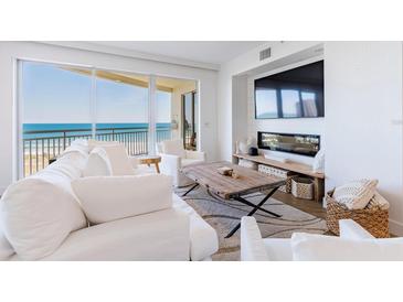 Bright and airy living room with ocean views, comfortable seating, and a modern fireplace at 1200 Gulf Blvd # 902, Clearwater Beach, FL 33767
