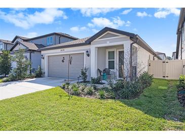 Charming single-story home with a well-manicured lawn and inviting front porch at 20778 Balsam Hill Rd, Land O Lakes, FL 34638