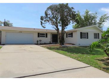 Charming single-story home featuring a well-manicured front yard and attached garage at 3094 Vernon Ter, Largo, FL 33770