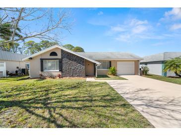 Charming single-Gathering home with well-maintained lawn, neutral paint, and a stone accent wall at 3639 Richboro Dr, Holiday, FL 34691