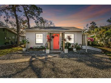 Charming single-story home with a vibrant pink door and well-maintained gravel landscaping at 6202 Tennessee Ave, New Port Richey, FL 34653