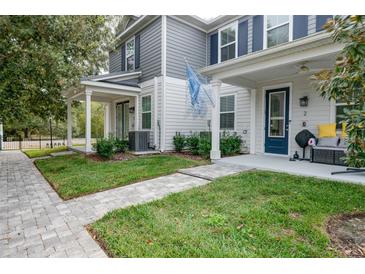 Charming townhome with a covered front porch and manicured lawn at 6615 S Manhattan Ave # 2, Tampa, FL 33616