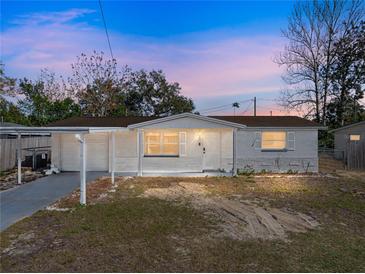 Charming single-story home featuring a carport, front yard, and freshly painted exterior at 7305 Windsor St, Hudson, FL 34667