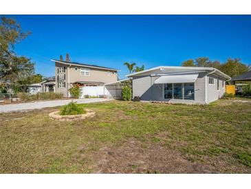 This home features a spacious yard and a charming exterior with a fenced-in area for added privacy and security at 101 Sunlit Cove Ne Dr, St Petersburg, FL 33702