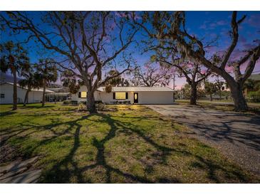 Charming single-story home featuring a mature landscaped yard with beautiful trees and a private driveway at 1019 Canal St, Ruskin, FL 33570