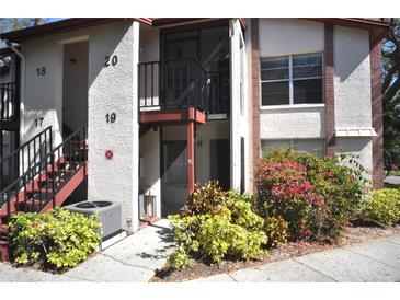 Attractive condo building with well-maintained landscaping and clearly marked unit numbers at 3455 Countryside Blvd # 19, Clearwater, FL 33761