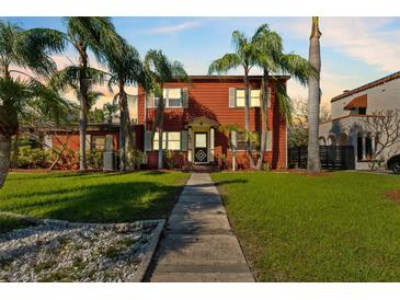 Charming two-story home with mature landscaping and inviting walkway to the front door at 681 Jasmine S Way, St Petersburg, FL 33705