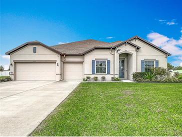 Beautiful single Gathering home with well maintained lawn, shutters, and a three car garage at 9820 Monaghan St, Thonotosassa, FL 33592