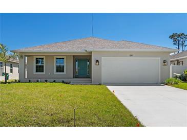 Charming single-story home featuring a two-car garage and well-maintained front lawn at 109 Beau Rivage Dr, Rotonda West, FL 33947
