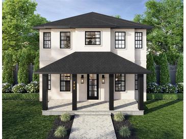 Charming two-story home featuring a covered porch, black framed windows, and well manicured landscaping at 2711 13Th N St, St Petersburg, FL 33704