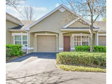 Charming home with a garage, well-maintained landscaping, and a cozy front entrance, offering great curb appeal at 3638 Trafalgar Way # 103, Palm Harbor, FL 34685