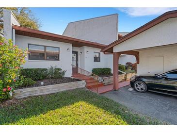 Charming single-story home with attached carport and well-maintained landscaping at 7623 Radcliffe Cir # A101, Port Richey, FL 34668