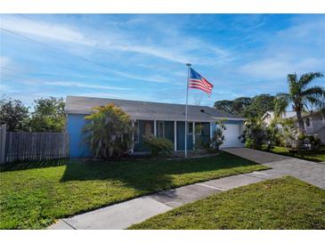 Charming single-story home boasts a well-maintained lawn, mature landscaping, and a prominent American flag at 8918 Country Square Dr, Seminole, FL 33777