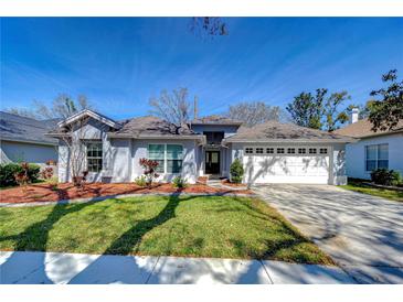 Charming home features a manicured lawn, two-car garage, and inviting front entrance at 3115 Bent Creek Dr, Valrico, FL 33596