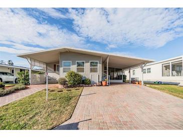 Charming single-story home featuring a covered carport and well-maintained front yard at 36745 Kimela Ave, Zephyrhills, FL 33542