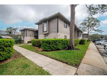 Charming two-story building with landscaped yard and sidewalk at 4112 Ashford Green Pl # I203, Tampa, FL 33613