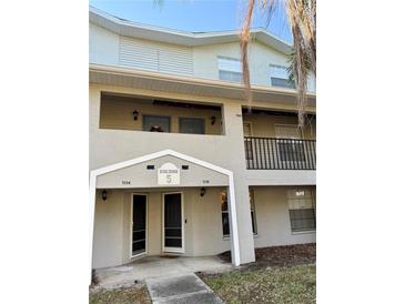 Inviting condo exterior with well-kept landscaping and classic architectural details at 7138 E Bank Dr # 7138, Tampa, FL 33617