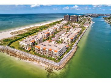 Expansive aerial view of beachfront condos, showcasing their proximity to the beautiful Gulf of Mexico at 7564 Bayshore Dr # 207, Treasure Island, FL 33706