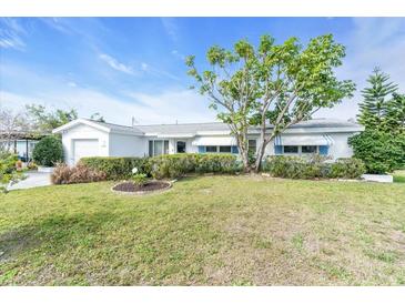 Charming single-story home with a well-manicured lawn and mature landscaping at 8490 7Th N Ln, St Petersburg, FL 33702