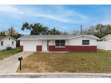 Charming single-story home with a well-maintained front yard and red brick accents at 1109 Landau St, Holiday, FL 34690